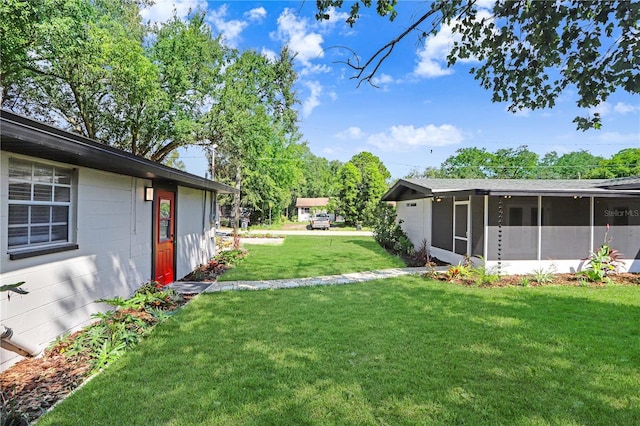 223 Pinehurst Dr, Auburndale, FL 33823 - view of green lawn with a sunroom