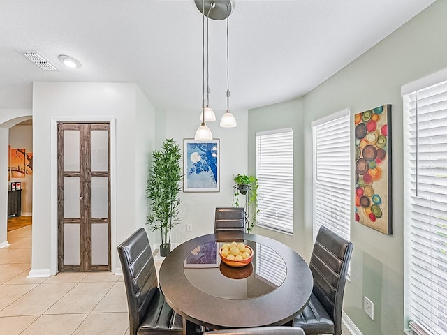 1338 Winding Willow Dr, Trinity, FL 34655 - dining room with arched walkways and light tile patterned floors