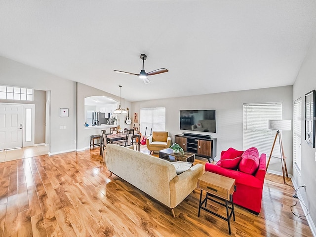 1338 Winding Willow Dr, Trinity, FL 34655 - living room with light wood finished floors, arched walkways, lofted ceiling, and a ceiling fan