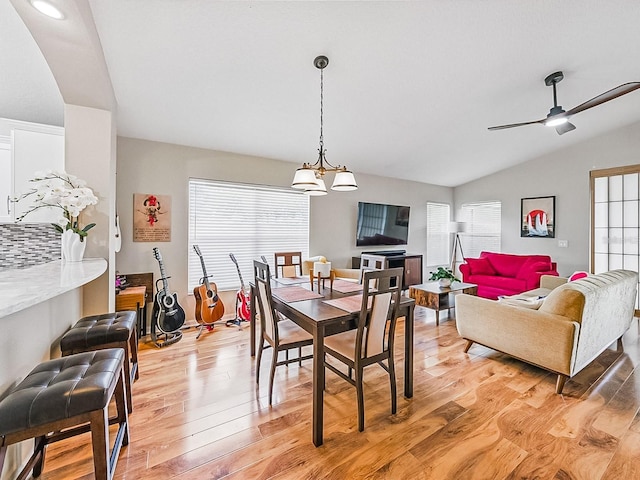 1338 Winding Willow Dr, Trinity, FL 34655 - dining area with lofted ceiling, light wood-style floors, a ceiling fan, and a chandelier