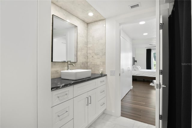1501 Gulf Blvd Unit 201, Clearwater Beach, FL 33767 - full bath featuring vanity, connected bathroom, recessed lighting, marble finish floors, and decorative backsplash