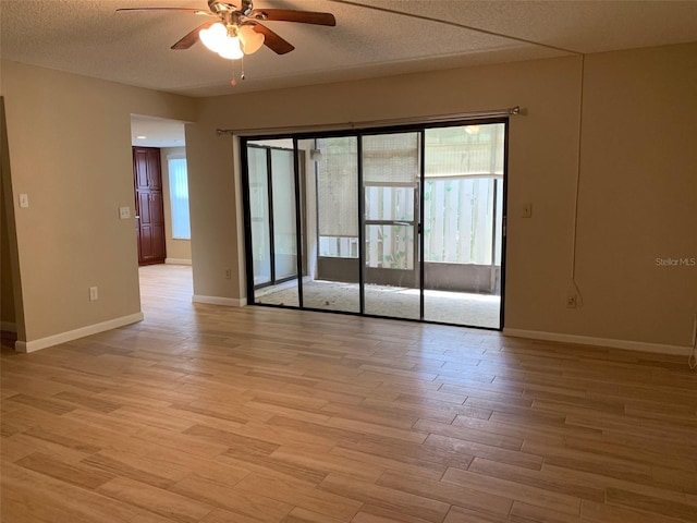 7821 Niagara Ave Unit 2102, Tampa, FL 33617 - spare room featuring a ceiling fan, light wood finished floors, a textured ceiling, and baseboards