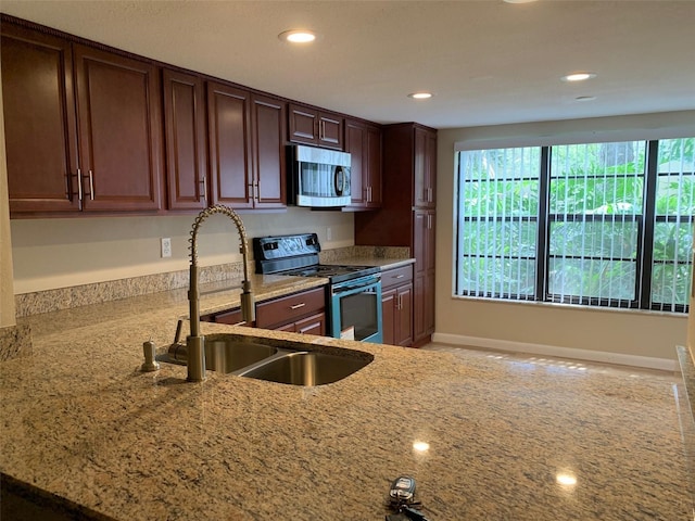 7821 Niagara Ave Unit 2102, Tampa, FL 33617 - kitchen featuring stainless steel microwave, electric stove, light stone counters, recessed lighting, and a sink