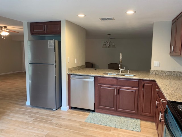7821 Niagara Ave Unit 2102, Tampa, FL 33617 - kitchen featuring appliances with stainless steel finishes, a sink, a ceiling fan, light wood-style floors, and recessed lighting