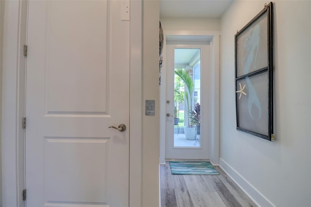 803 Oak Bend Ln, Dunedin, FL 34698 - doorway to outside featuring wood finished floors and baseboards