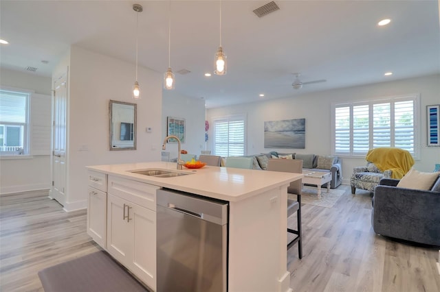 803 Oak Bend Ln, Dunedin, FL 34698 - kitchen featuring dishwasher, open floor plan, ceiling fan, pendant lighting, and light wood-style floors