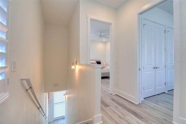 803 Oak Bend Ln, Dunedin, FL 34698 - corridor with an upstairs landing and light wood-style flooring