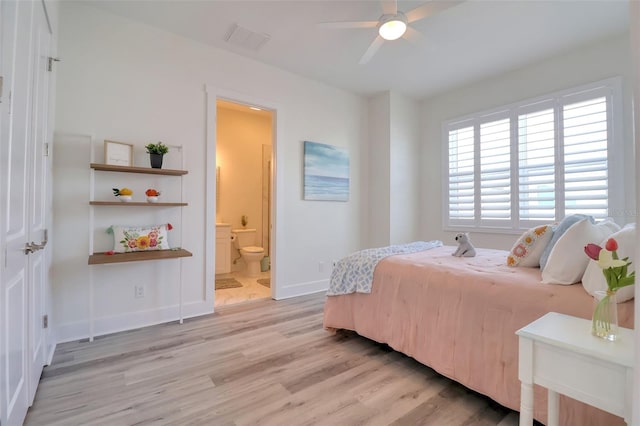 803 Oak Bend Ln, Dunedin, FL 34698 - bedroom with light wood-style floors, ensuite bathroom, and ceiling fan