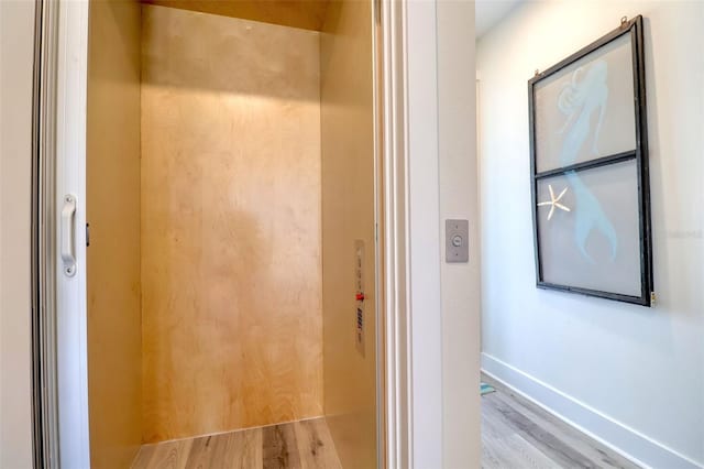 803 Oak Bend Ln, Dunedin, FL 34698 - elevator featuring wood finished floors and baseboards