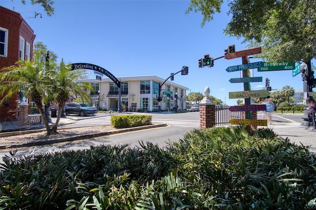 803 Oak Bend Ln, Dunedin, FL 34698 - view of asphalt street with traffic lights, sidewalks, curbs, and street lights