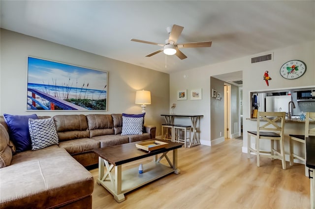 282 Treasure Island Cswy Unit 12, Treasure Island, FL 33706 - living room with ceiling fan and light wood-style flooring
