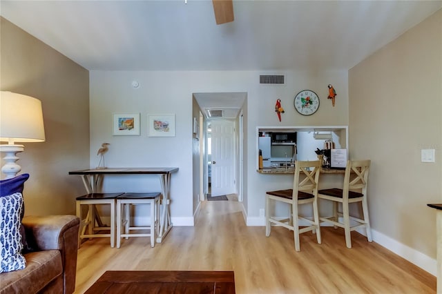 282 Treasure Island Cswy Unit 12, Treasure Island, FL 33706 - living area featuring wood finished floors, a desk, and ceiling fan