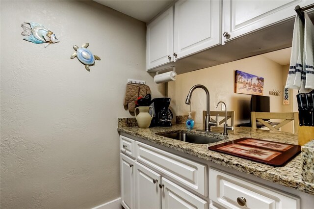 282 Treasure Island Cswy Unit 12, Treasure Island, FL 33706 - kitchen with white cabinetry and light stone counters