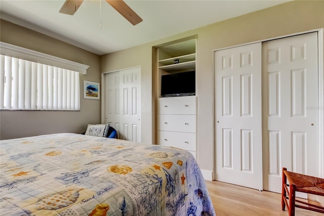 282 Treasure Island Cswy Unit 12, Treasure Island, FL 33706 - bedroom with two closets, light wood-style flooring, and a ceiling fan