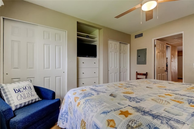 282 Treasure Island Cswy Unit 12, Treasure Island, FL 33706 - bedroom featuring electric panel, two closets, attic access, and a ceiling fan