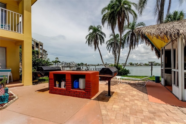 282 Treasure Island Cswy Unit 12, Treasure Island, FL 33706 - view of patio / terrace featuring a water view and a grill