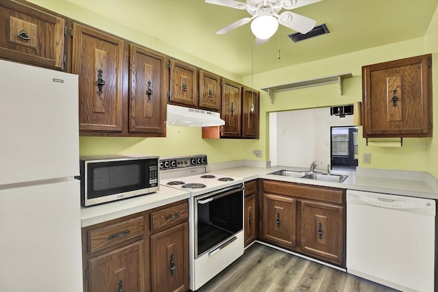 1206 10th Cir SE, Largo, FL 33771 - kitchen featuring white appliances, under cabinet range hood, ceiling fan, light countertops, and wood finished floors