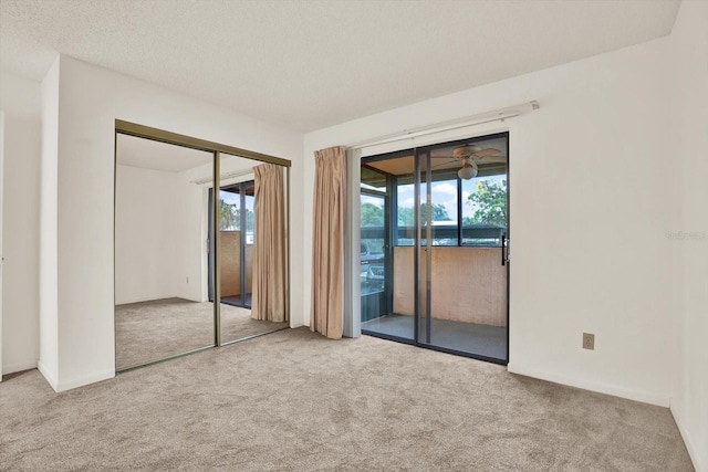 1206 10th Cir SE, Largo, FL 33771 - unfurnished bedroom with carpet, access to outside, multiple windows, and a closet