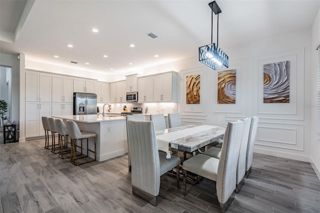 3197 Acacia Bay Ave, Wesley Chapel, FL 33543 - dining room with light wood-style flooring and recessed lighting