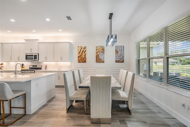 3197 Acacia Bay Ave, Wesley Chapel, FL 33543 - dining space featuring light wood-style floors and recessed lighting