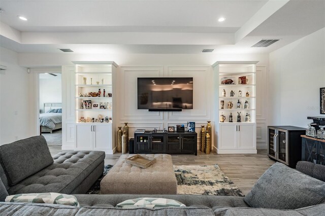 3197 Acacia Bay Ave, Wesley Chapel, FL 33543 - living area with a raised ceiling, wood finished floors, recessed lighting, and built in shelves