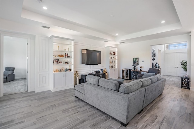 3197 Acacia Bay Ave, Wesley Chapel, FL 33543 - living area featuring a raised ceiling, light wood finished floors, and recessed lighting