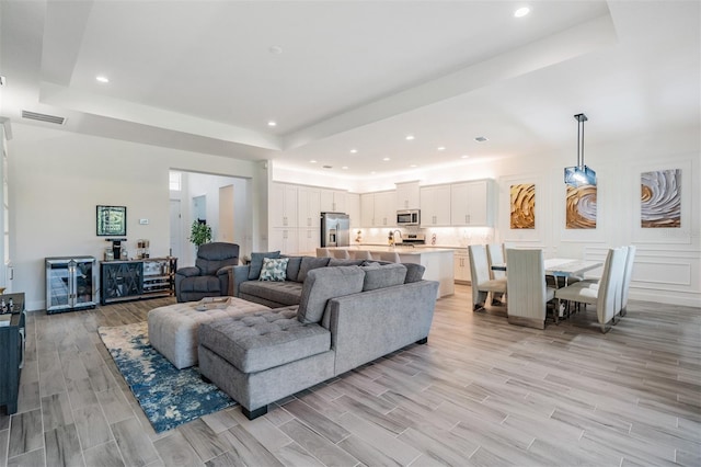 3197 Acacia Bay Ave, Wesley Chapel, FL 33543 - living room with a raised ceiling, light wood finished floors, and recessed lighting
