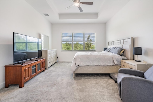 3197 Acacia Bay Ave, Wesley Chapel, FL 33543 - bedroom featuring multiple windows, light carpet, a tray ceiling, and a ceiling fan