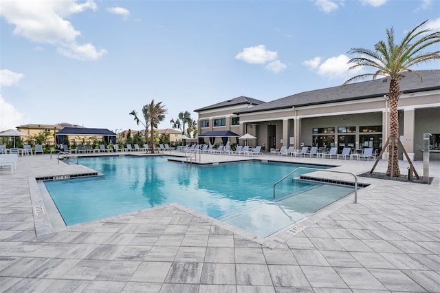 3197 Acacia Bay Ave, Wesley Chapel, FL 33543 - community pool featuring a patio area