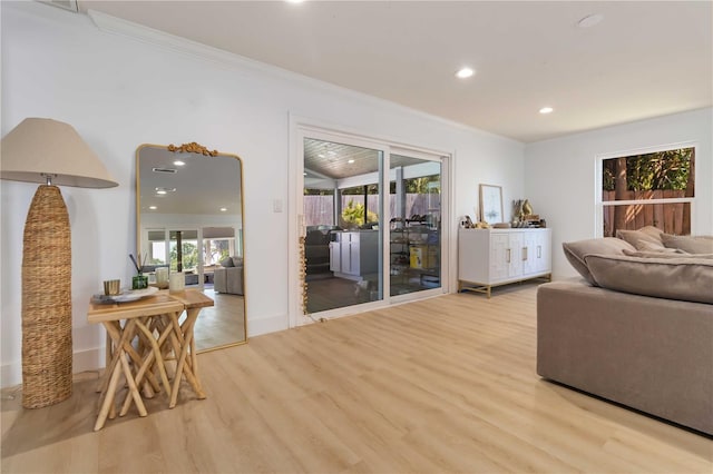 711 N Indian River Dr, Cocoa, FL 32922 - living room featuring light wood-type flooring, recessed lighting, ornamental molding, and baseboards
