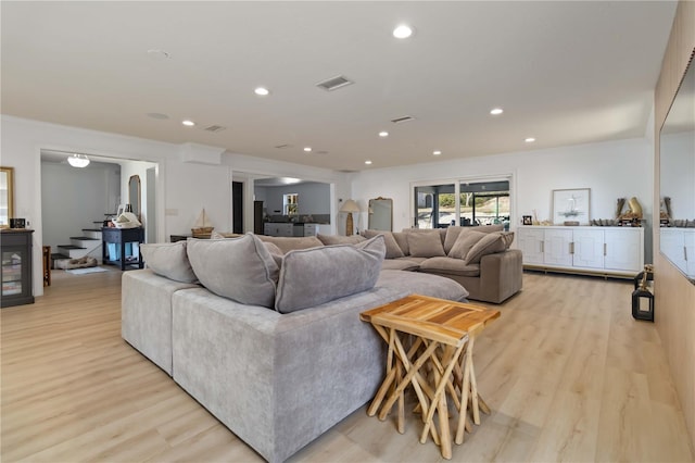 711 N Indian River Dr, Cocoa, FL 32922 - living area with light wood-type flooring, recessed lighting, and stairs