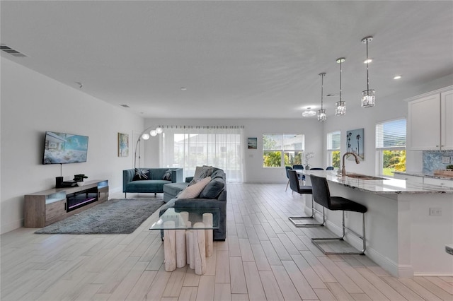 5415 Limelight Dr, Apollo Beach, FL 33572 - living area with light wood-type flooring and recessed lighting