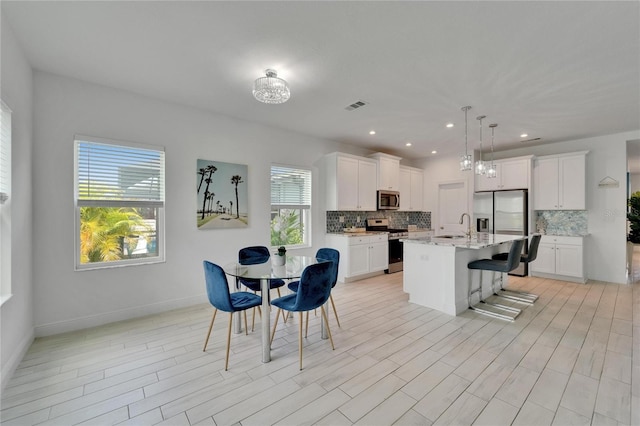 5415 Limelight Dr, Apollo Beach, FL 33572 - dining room with light wood finished floors and recessed lighting