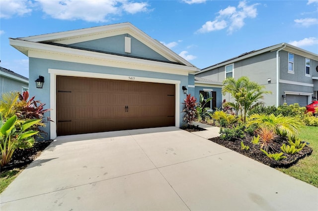 5415 Limelight Dr, Apollo Beach, FL 33572 - view of front of property featuring stucco siding, an attached garage, and driveway