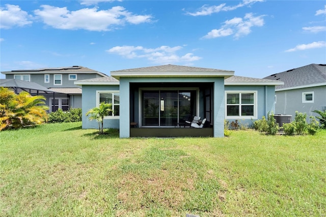 5415 Limelight Dr, Apollo Beach, FL 33572 - back of property featuring stucco siding, a lawn, and a sunroom