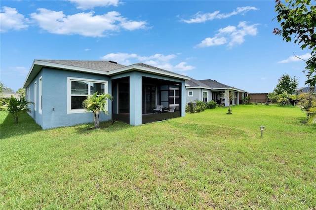 5415 Limelight Dr, Apollo Beach, FL 33572 - rear view of property with a yard, stucco siding, and a sunroom