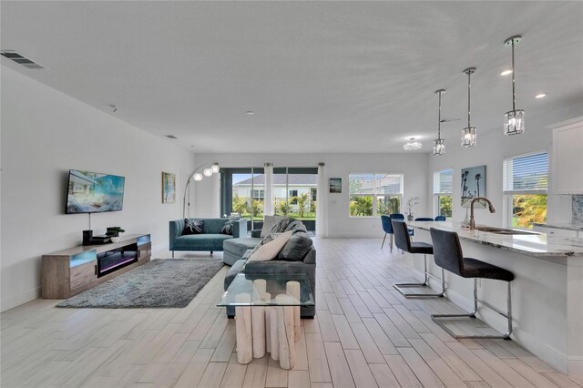 5415 Limelight Dr, Apollo Beach, FL 33572 - living room with light wood finished floors and recessed lighting
