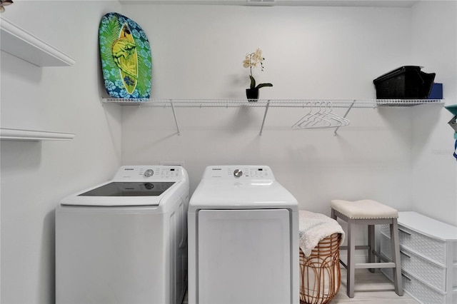 5415 Limelight Dr, Apollo Beach, FL 33572 - washroom with separate washer and dryer and light wood-type flooring