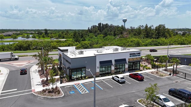 5415 Limelight Dr, Apollo Beach, FL 33572 - view of building exterior with uncovered parking and a water view
