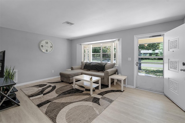 2481 12th Ave SW, Largo, FL 33770 - living area featuring light wood-style floors and baseboards