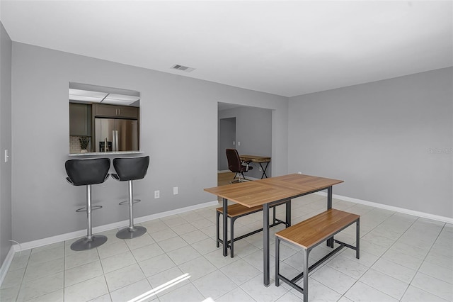 2481 12th Ave SW, Largo, FL 33770 - dining room with light tile patterned floors and baseboards