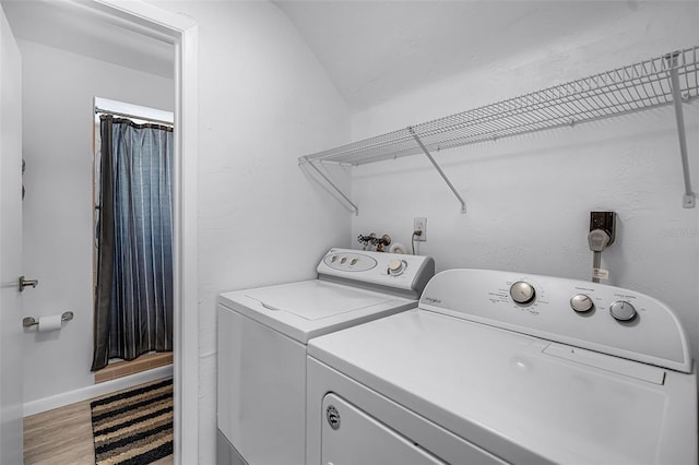 2481 12th Ave SW, Largo, FL 33770 - laundry room featuring washing machine and clothes dryer and light wood-type flooring