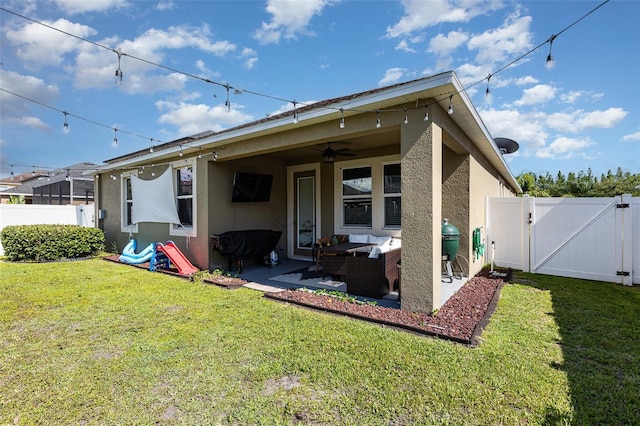 11711 Winterset Cove Dr, Riverview, FL 33579 - back of house with a gate, stucco siding, a ceiling fan, outdoor lounge area, and a fenced backyard