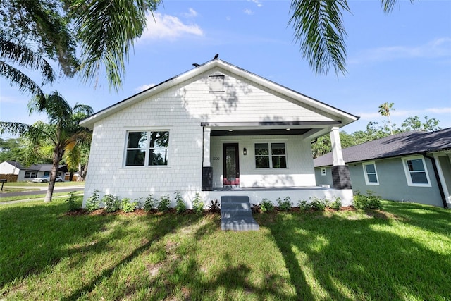 5709 N 20th St, Tampa, FL 33610 - bungalow featuring covered porch and a front lawn