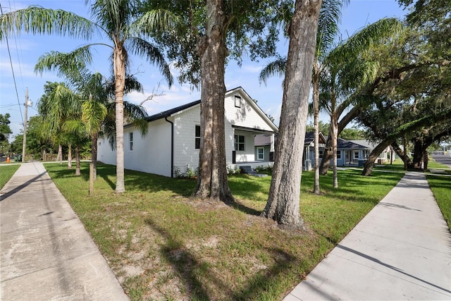 5709 N 20th St, Tampa, FL 33610 - view of home's exterior with a lawn
