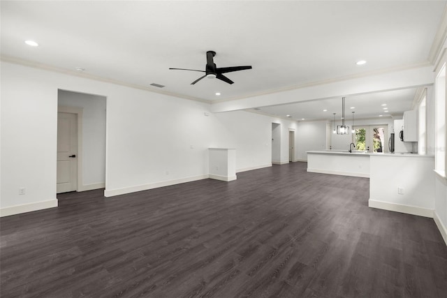 5709 N 20th St, Tampa, FL 33610 - unfurnished living room featuring a ceiling fan, recessed lighting, dark wood-style floors, and ornamental molding