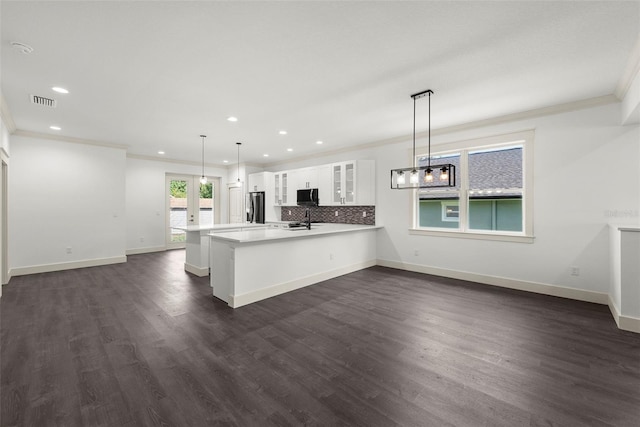 5709 N 20th St, Tampa, FL 33610 - kitchen featuring stainless steel fridge, black microwave, recessed lighting, ornamental molding, and glass insert cabinets
