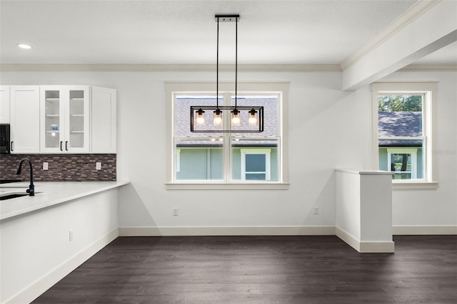 5709 N 20th St, Tampa, FL 33610 - unfurnished dining area with crown molding, dark wood-style flooring, and recessed lighting