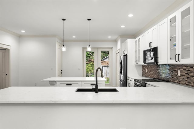 5709 N 20th St, Tampa, FL 33610 - kitchen featuring black microwave, freestanding refrigerator, backsplash, crown molding, and recessed lighting