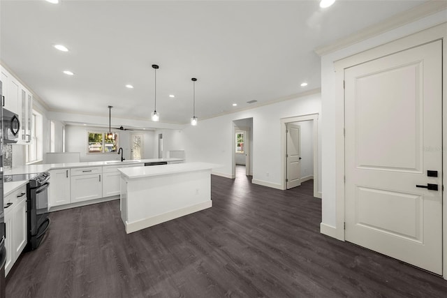 5709 N 20th St, Tampa, FL 33610 - kitchen featuring black appliances, crown molding, recessed lighting, a kitchen island, and white cabinetry